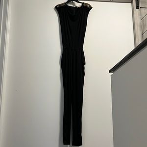 MK soft black jumpsuit with gold rhinestones on sleeves.